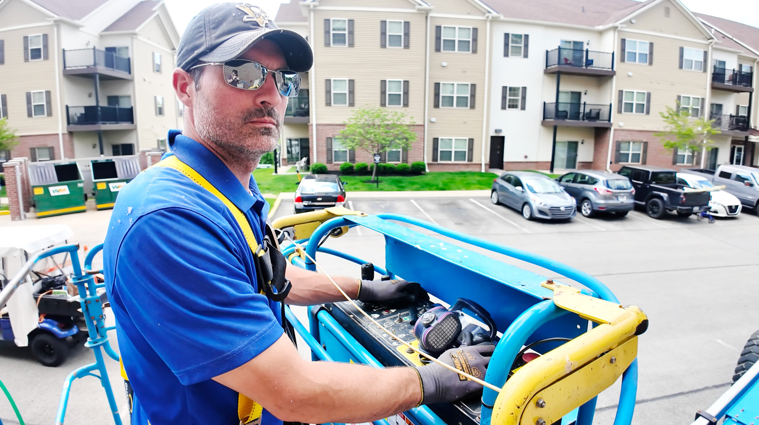 Jon on Lift at Apartments Jon Sligh on a lift servicing an apartment complex